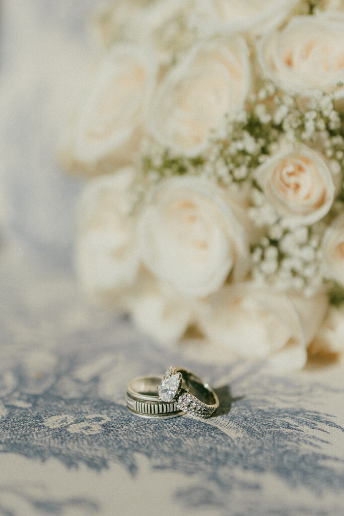 Two wedding rings with bouquet of roses