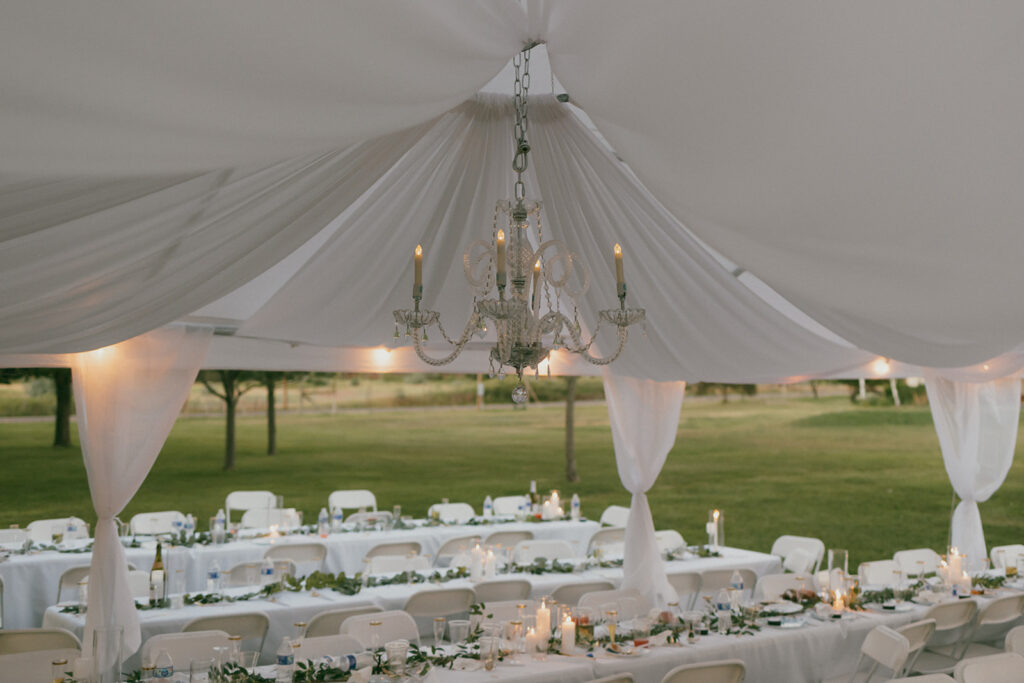 Reception tent details, white draped ceiling and chandelier 