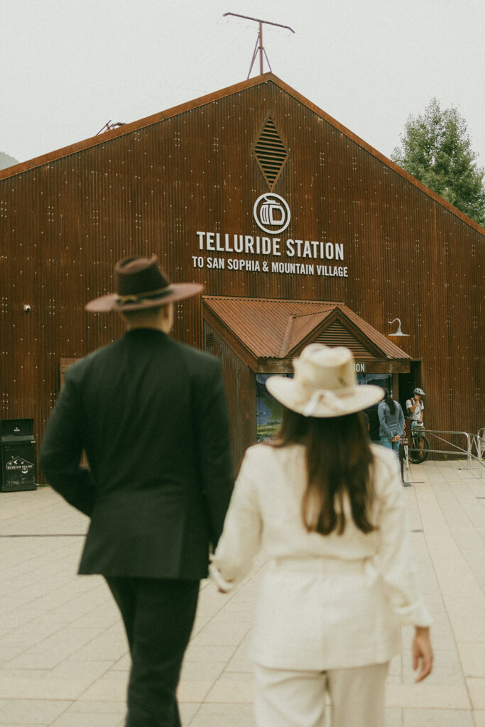 A couple on their elopement day in Telluride, CO about to get onto a gondola at the station