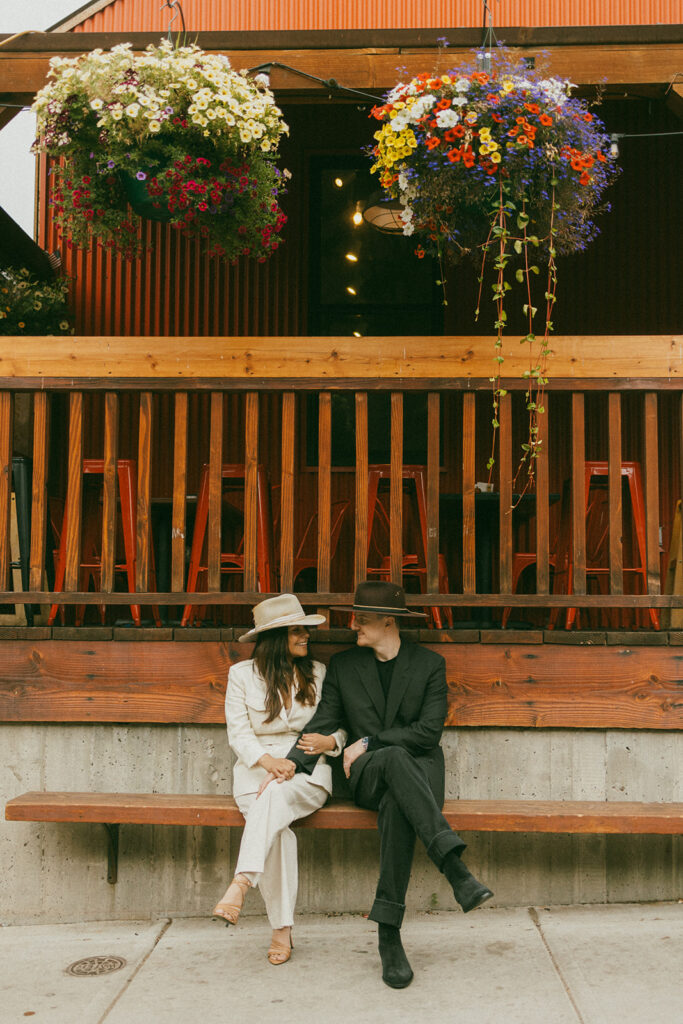 A couple on their elopement day in front of a cafe