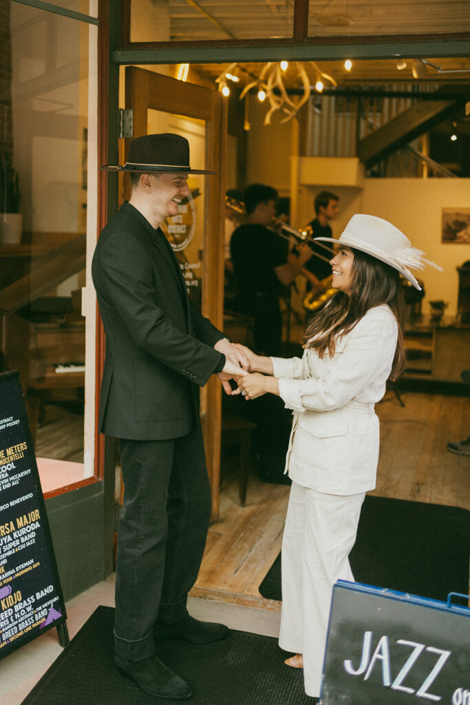 A couple on their elopement day dancing in front of a jazz band