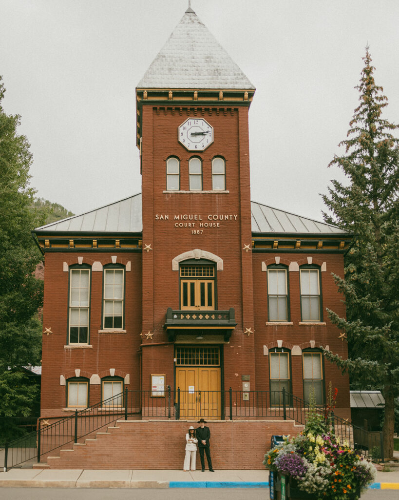 A couple on their elopement day outside of the Telluride, CO courthouse 