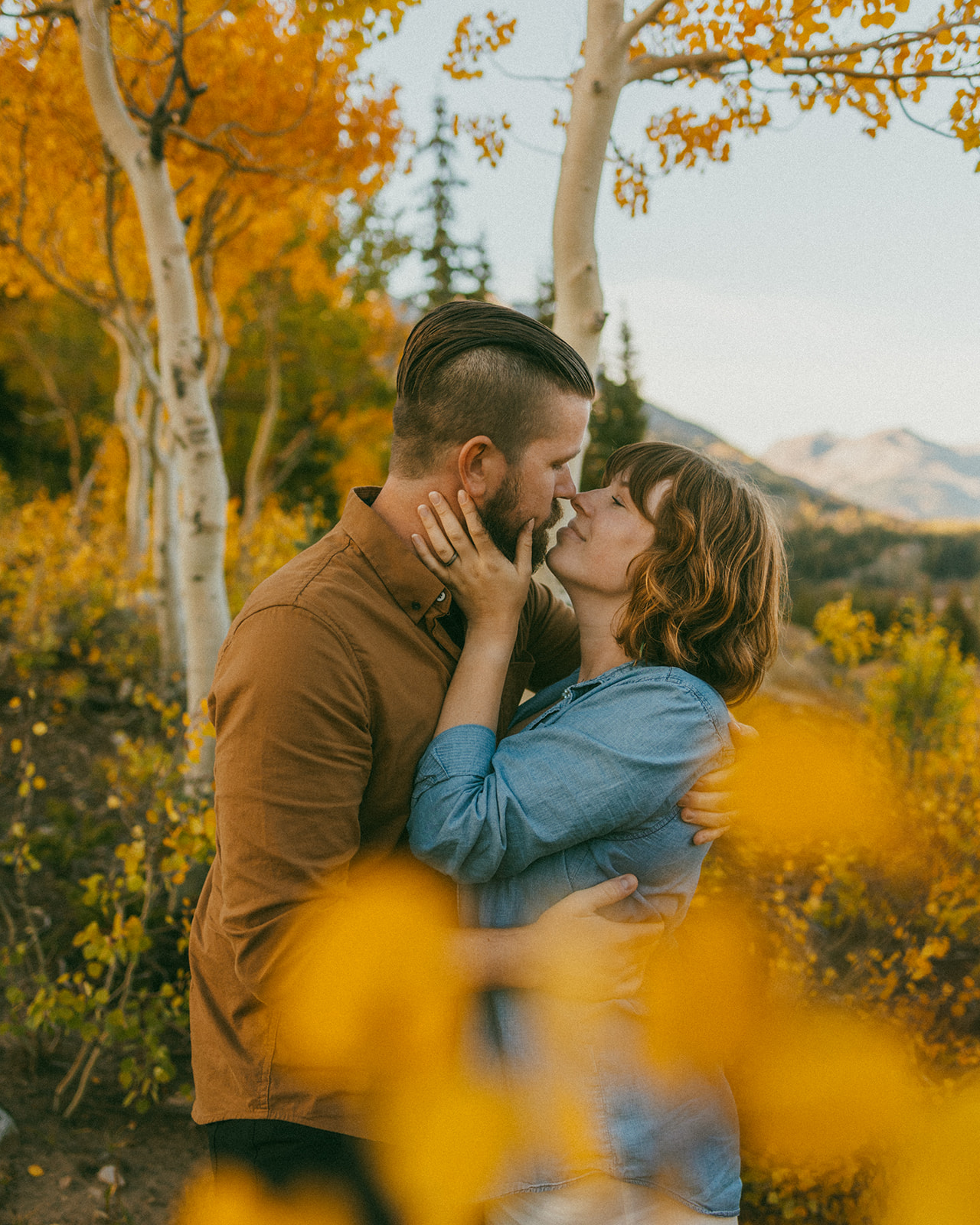 A newly engaged couple in the fall leaves at Molas Pass Overlook in Silverton, CO